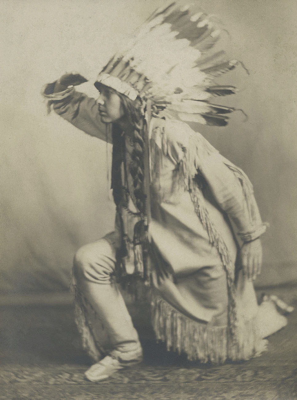Te Ata posing in a Native American headdress.